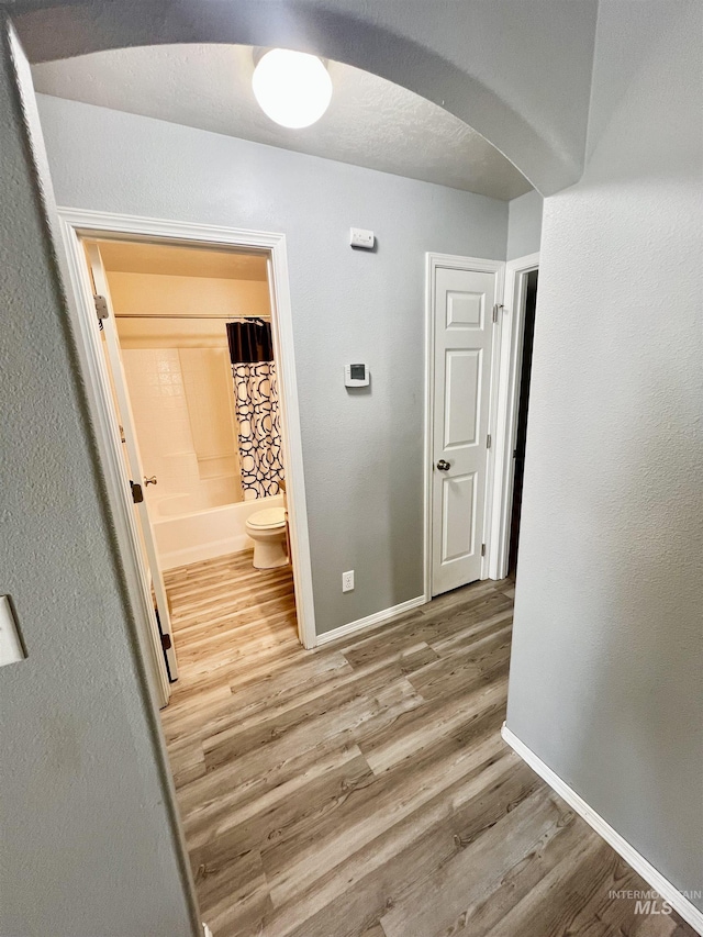 981 SW Independence, Mountain Home, ID 83647 - hall featuring arched walkways, baseboards, and wood finished floors
