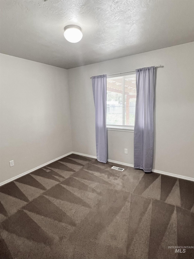 981 SW Independence, Mountain Home, ID 83647 - spare room featuring visible vents, a textured ceiling, carpet, and baseboards