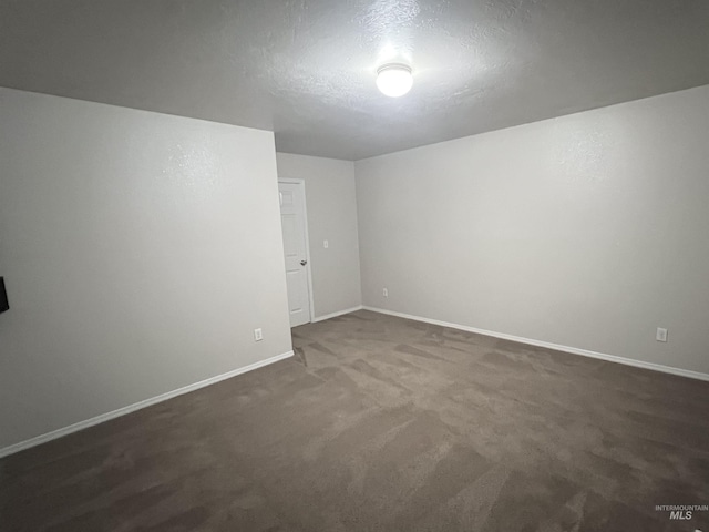 981 SW Independence, Mountain Home, ID 83647 - empty room with baseboards, a textured ceiling, and dark colored carpet