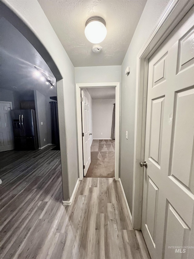 981 SW Independence, Mountain Home, ID 83647 - hallway featuring light wood-type flooring, a textured ceiling, and baseboards
