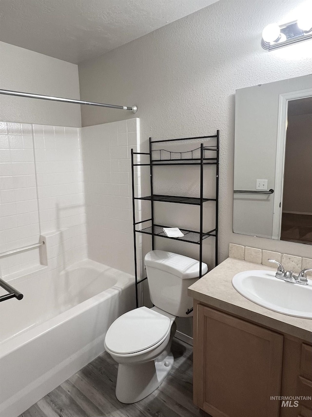 981 SW Independence, Mountain Home, ID 83647 - full bathroom with toilet, wood finished floors, shower / washtub combination, a textured wall, and vanity