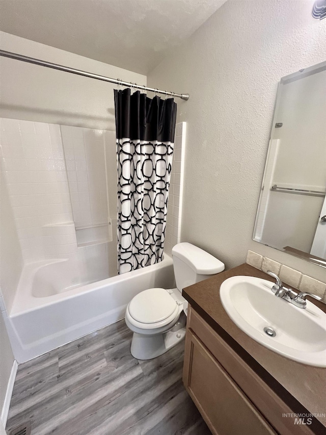 981 SW Independence, Mountain Home, ID 83647 - full bathroom with a textured wall, vanity, toilet, shower / bathtub combination with curtain, and wood finished floors