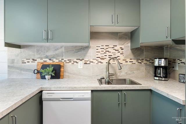 946 S Curtis Rd, Boise, ID 83705 - kitchen with white dishwasher, a sink, light countertops, backsplash, and green cabinets