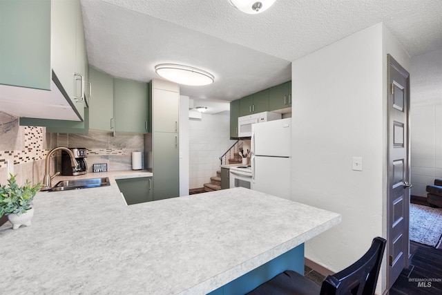 946 S Curtis Rd, Boise, ID 83705 - kitchen with a sink, green cabinetry, light countertops, white appliances, and a peninsula