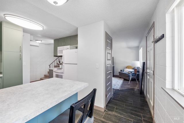 946 S Curtis Rd, Boise, ID 83705 - kitchen with light countertops, a breakfast bar, white appliances, tile walls, and wood tiled floors