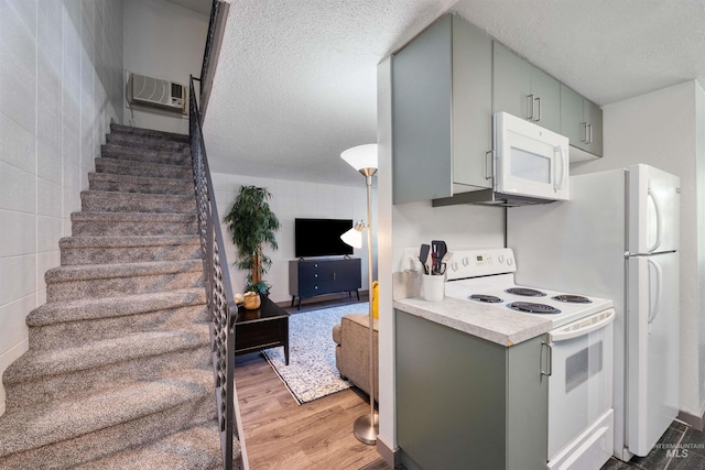 946 S Curtis Rd, Boise, ID 83705 - kitchen with white appliances, gray cabinets, a textured ceiling, light countertops, and light wood-style flooring