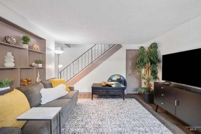 946 S Curtis Rd, Boise, ID 83705 - living room featuring wood finished floors, a textured ceiling, and stairs