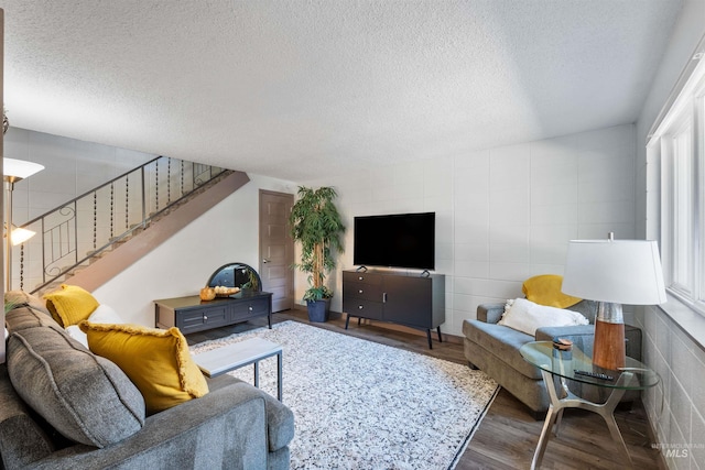 946 S Curtis Rd, Boise, ID 83705 - living room with a textured ceiling, wood finished floors, stairway, and tile walls