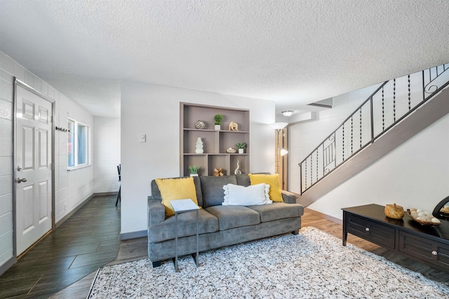 946 S Curtis Rd, Boise, ID 83705 - living room with stairway, a textured ceiling, wood finished floors, baseboards, and built in shelves