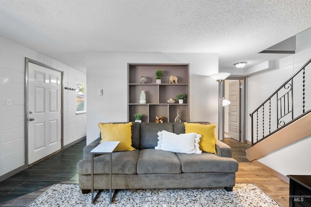 946 S Curtis Rd, Boise, ID 83705 - living area featuring wood finished floors, stairs, a textured ceiling, and baseboards