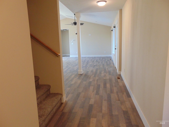 hall with dark hardwood / wood-style floors and vaulted ceiling