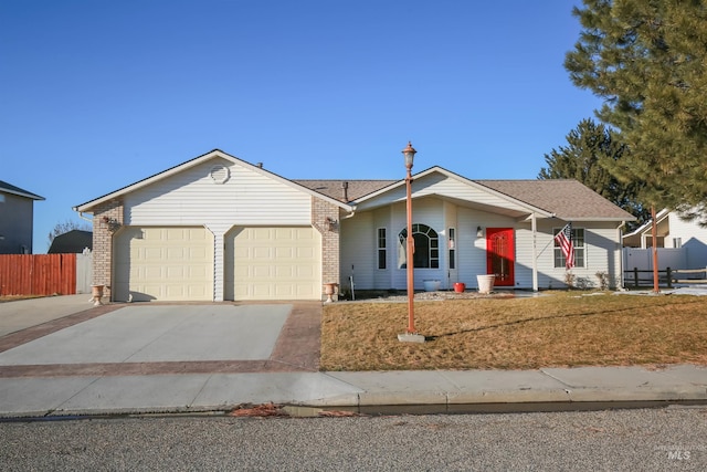 ranch-style home with a garage, concrete driveway, fence, a front lawn, and brick siding