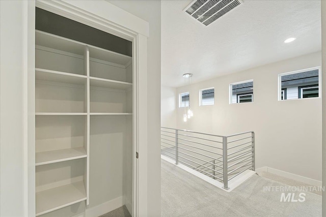 interior space featuring carpet and a textured ceiling