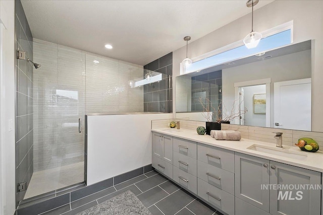 bathroom featuring tile patterned flooring, vanity, and a shower with shower door