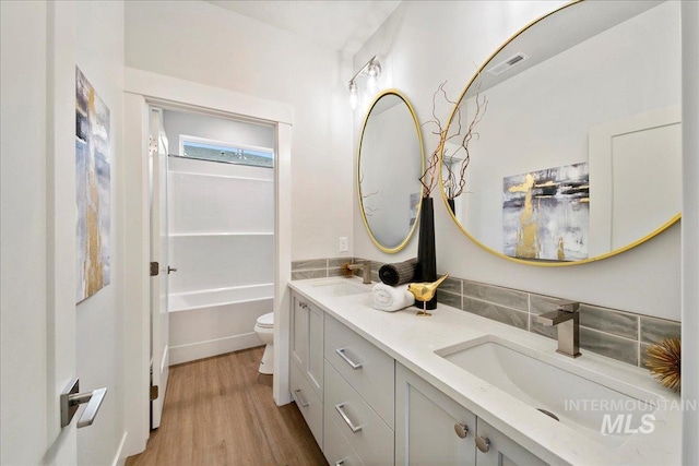 full bathroom featuring shower / bath combination, vanity, toilet, and wood-type flooring