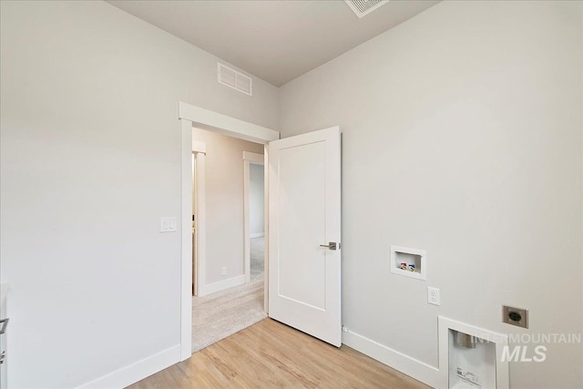 washroom featuring washer hookup, light wood-type flooring, and electric dryer hookup