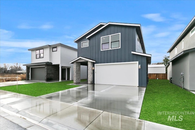 view of front of property with a garage and a front lawn