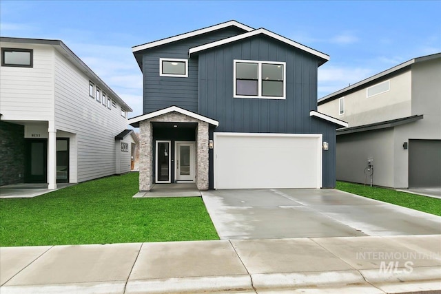 view of front of house with a garage and a front yard