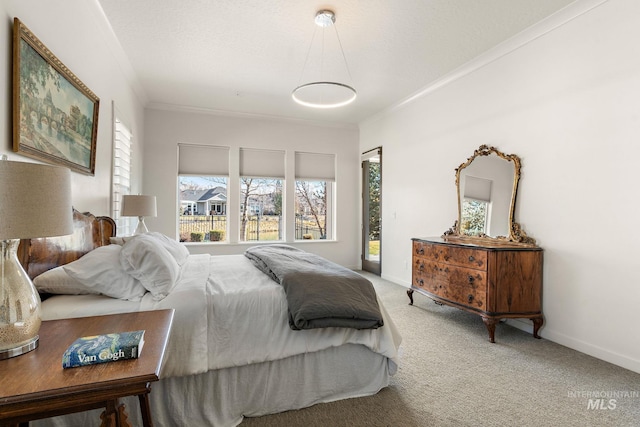 bedroom featuring ornamental molding, a textured ceiling, and carpet