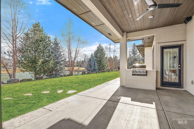 view of patio with area for grilling, grilling area, ceiling fan, and a water view