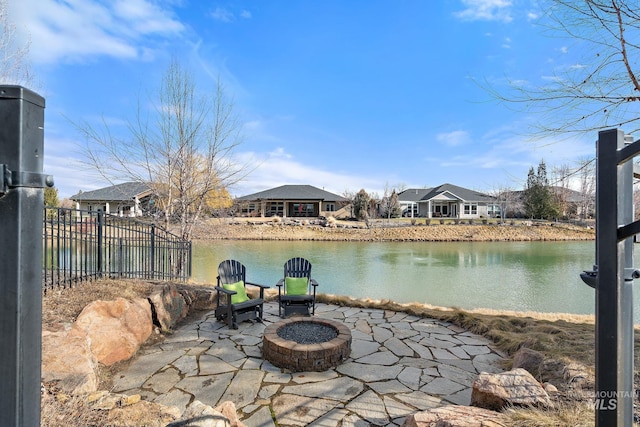 view of patio with a water view and an outdoor fire pit