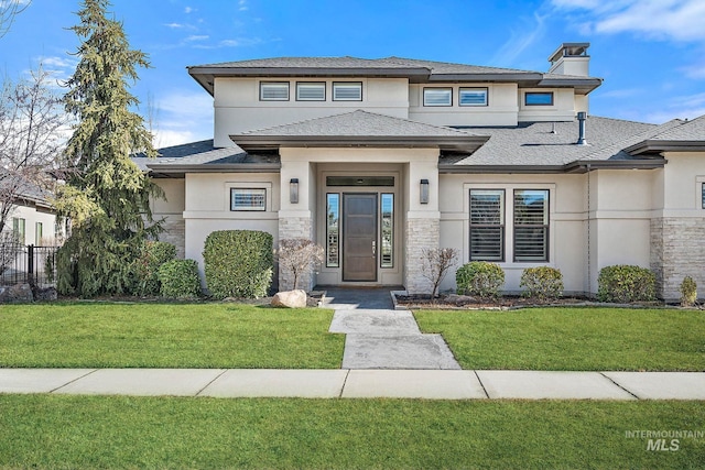 prairie-style home featuring a front lawn