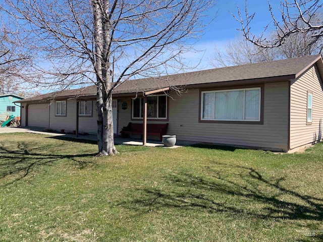 view of front of property featuring a garage and a front lawn