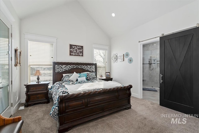 bedroom with light carpet, ensuite bath, high vaulted ceiling, and a barn door