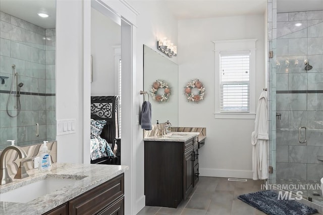 bathroom with tile patterned flooring, vanity, and walk in shower