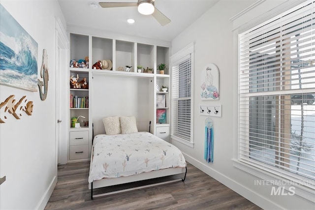 bedroom with dark hardwood / wood-style floors and ceiling fan