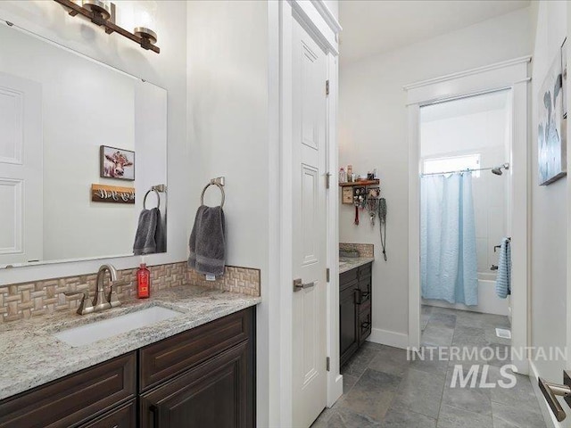 bathroom with shower / bath combination with curtain, vanity, and backsplash