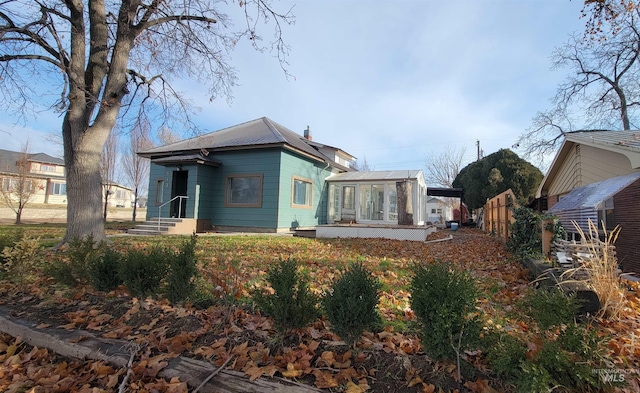 rear view of property with a sunroom