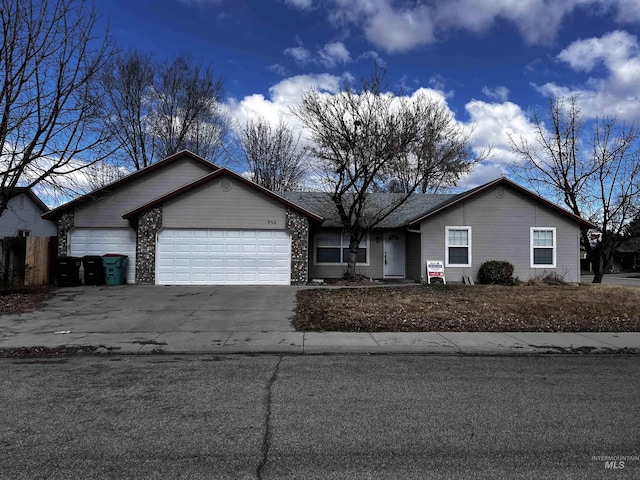 single story home with a garage and concrete driveway