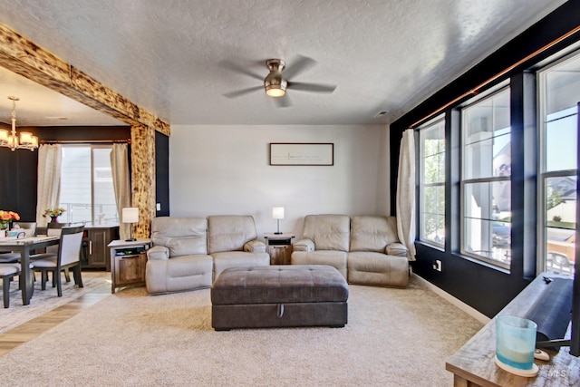 172 S Echo Canyon Ave, Meridian, ID 83642 - carpeted living area featuring baseboards, a textured ceiling, and ceiling fan with notable chandelier