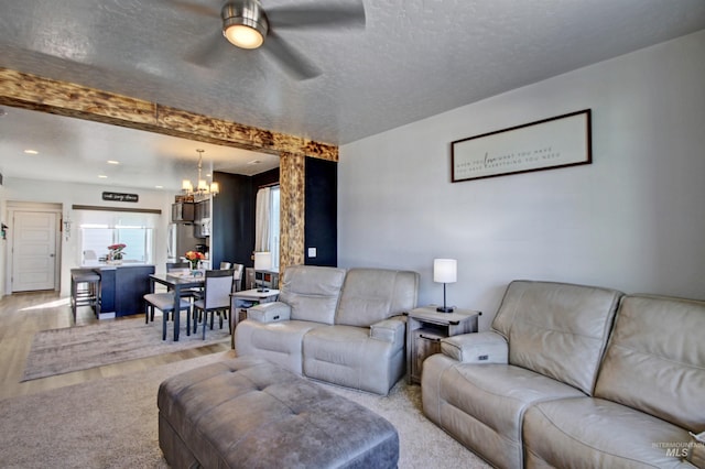 172 S Echo Canyon Ave, Meridian, ID 83642 - living room with recessed lighting, a textured ceiling, light wood finished floors, and ceiling fan with notable chandelier