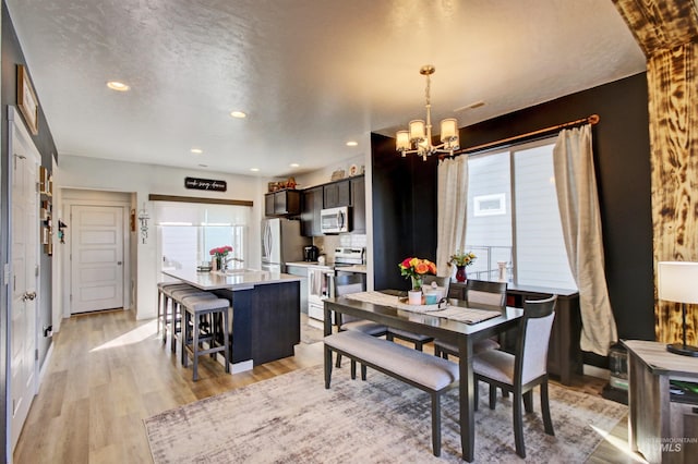 172 S Echo Canyon Ave, Meridian, ID 83642 - dining space with light wood finished floors, visible vents, recessed lighting, and a chandelier