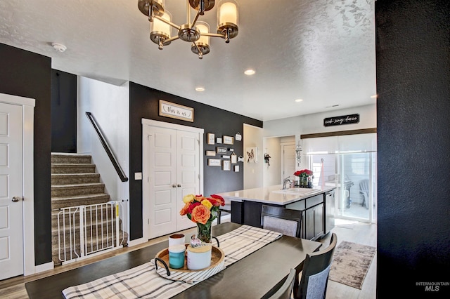 172 S Echo Canyon Ave, Meridian, ID 83642 - dining area with a chandelier, wood finished floors, stairway, and recessed lighting