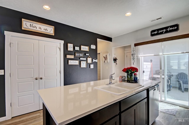172 S Echo Canyon Ave, Meridian, ID 83642 - kitchen with an island with sink, dishwasher, visible vents, a sink, and light wood-style floors