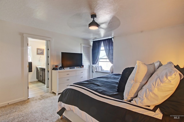 172 S Echo Canyon Ave, Meridian, ID 83642 - bedroom featuring light carpet, baseboards, connected bathroom, and ceiling fan
