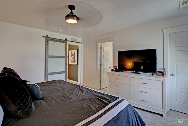 172 S Echo Canyon Ave, Meridian, ID 83642 - bedroom with a barn door, visible vents, light colored carpet, and ceiling fan