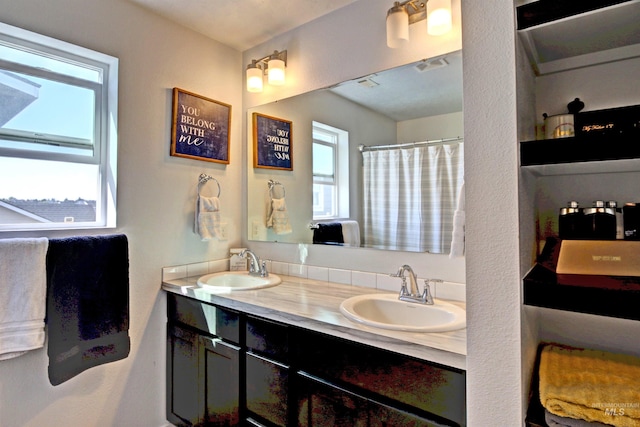 172 S Echo Canyon Ave, Meridian, ID 83642 - bathroom featuring visible vents, a shower with curtain, a sink, and double vanity