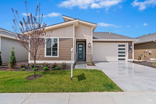 view of front of home with a garage and a front lawn