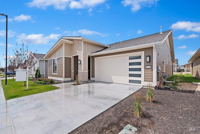 view of front of property featuring a garage and a front lawn