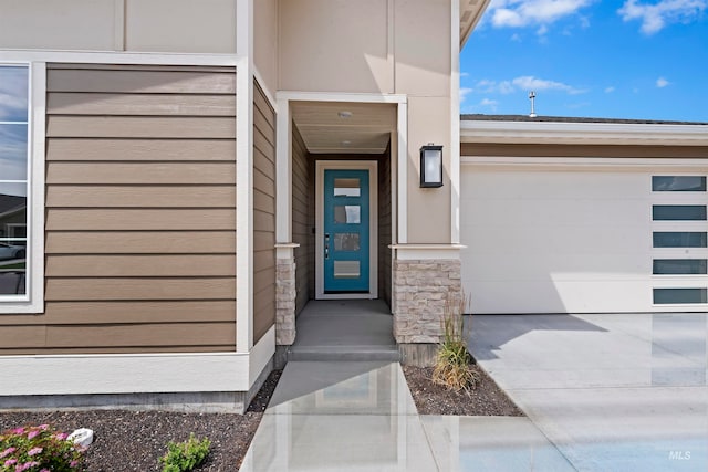 doorway to property with a garage