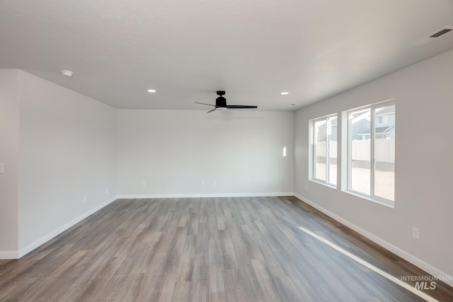 unfurnished room featuring light hardwood / wood-style floors and ceiling fan