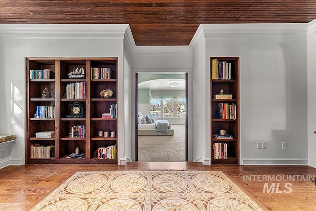 interior space featuring crown molding, hardwood / wood-style floors, and wooden ceiling