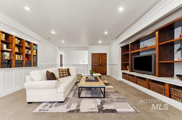 carpeted living room featuring built in shelves