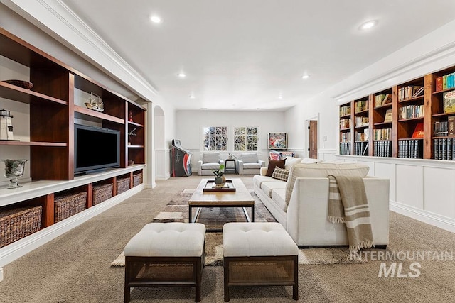 carpeted living room featuring built in shelves