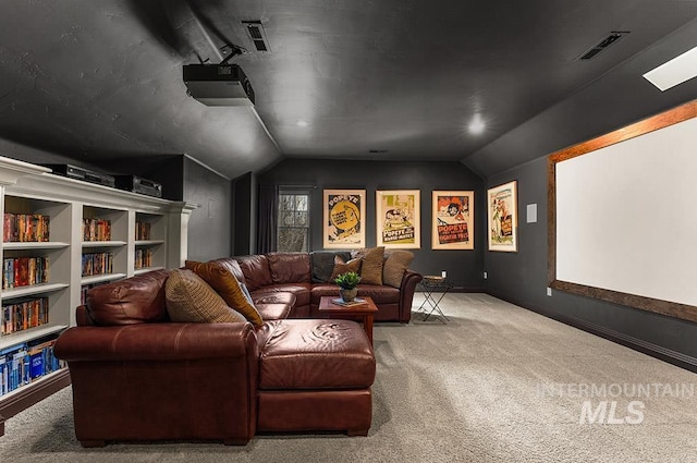 carpeted cinema room featuring lofted ceiling