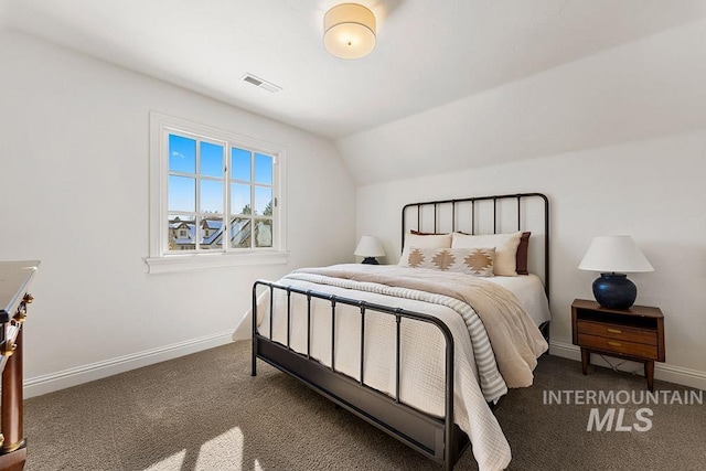 carpeted bedroom with lofted ceiling